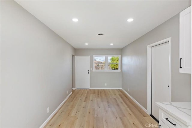 unfurnished room with light wood-type flooring