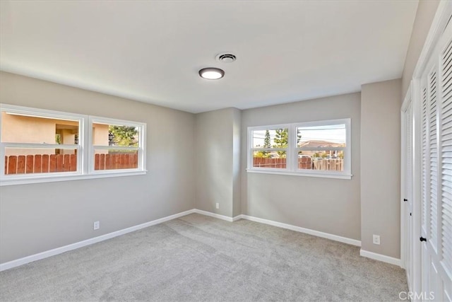 unfurnished bedroom with light colored carpet