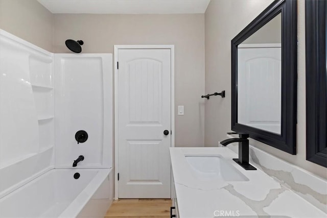 bathroom featuring shower / tub combination, vanity, and wood-type flooring