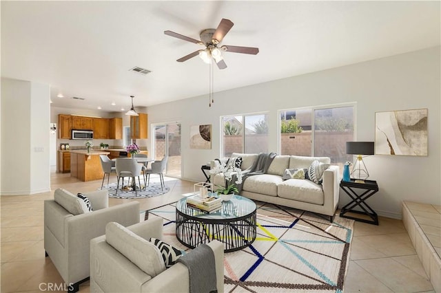 tiled living room featuring ceiling fan