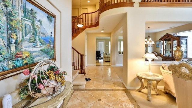 tiled foyer entrance featuring a chandelier