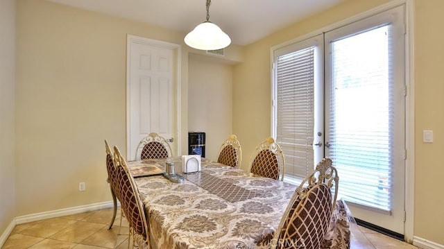 tiled dining room with a healthy amount of sunlight