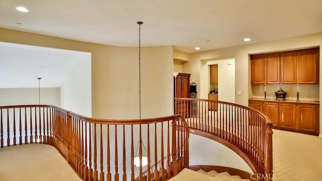 staircase featuring carpet floors