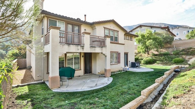 back of house with a yard, a balcony, and a patio