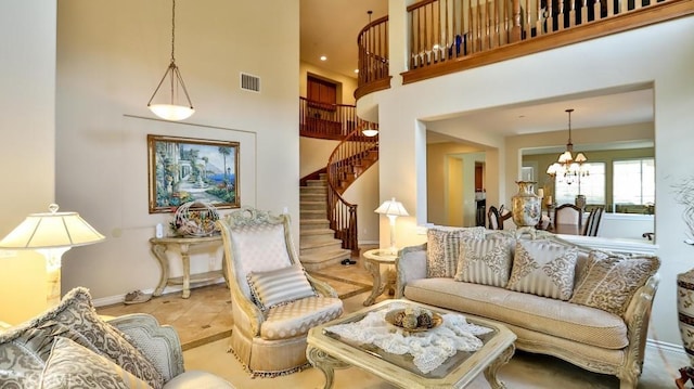 living room featuring a chandelier and a high ceiling