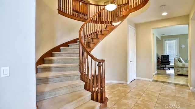 stairway featuring tile patterned flooring