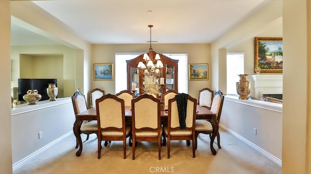 carpeted dining room with a notable chandelier