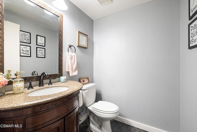 bathroom featuring tile patterned floors, vanity, and toilet