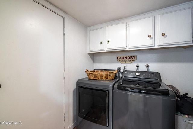 laundry area with cabinets and separate washer and dryer