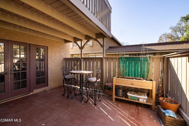 view of patio with a balcony and french doors