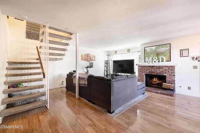 living room featuring a fireplace and light wood-type flooring