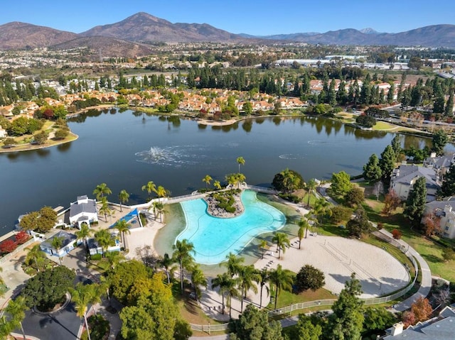 drone / aerial view featuring a water and mountain view