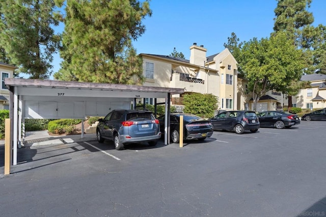 view of vehicle parking with a carport