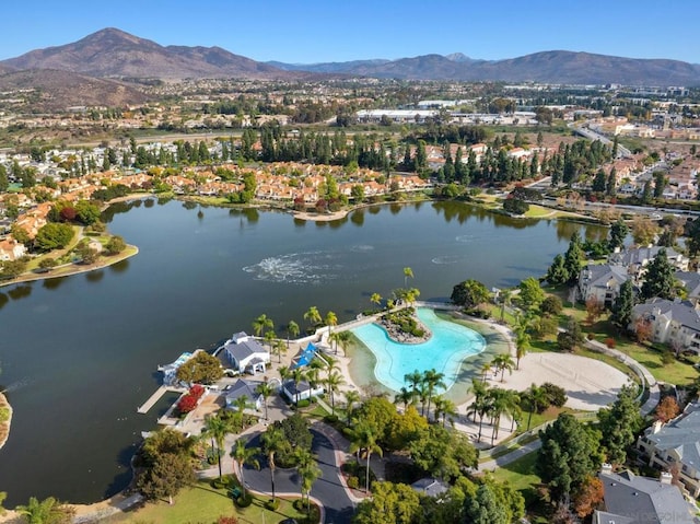 drone / aerial view featuring a water and mountain view