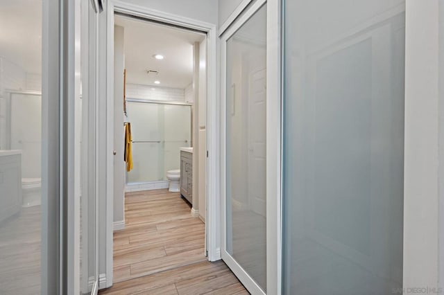 bathroom with vanity, hardwood / wood-style flooring, toilet, and walk in shower