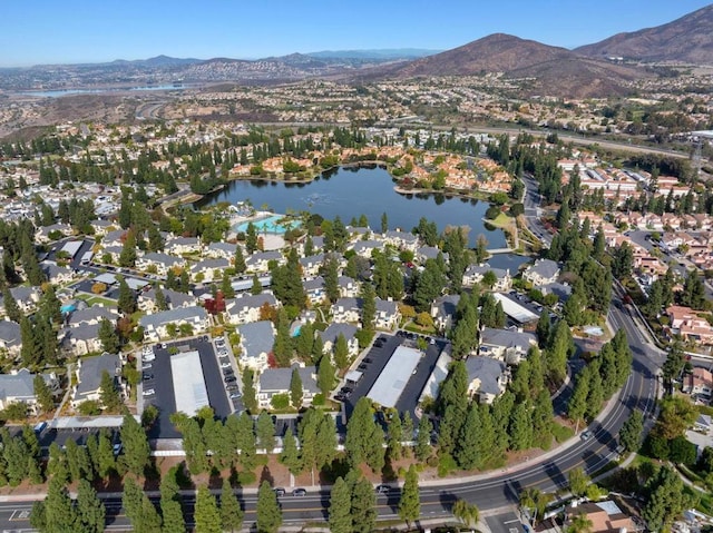 drone / aerial view with a water and mountain view