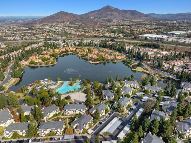 drone / aerial view with a water and mountain view