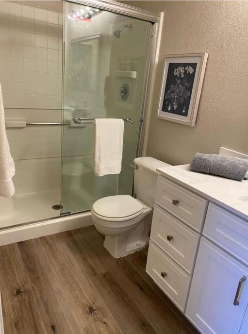 bathroom with vanity, hardwood / wood-style floors, and an enclosed shower