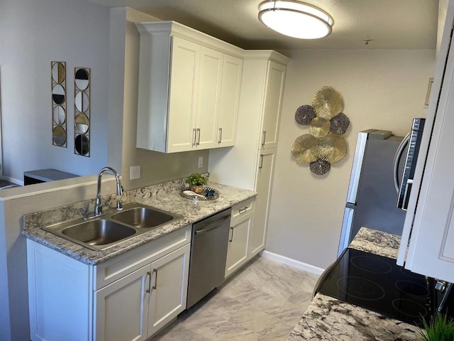 kitchen with sink, white cabinets, and appliances with stainless steel finishes