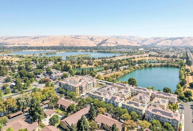 birds eye view of property featuring a water and mountain view