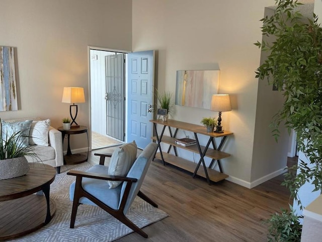 sitting room with dark hardwood / wood-style flooring