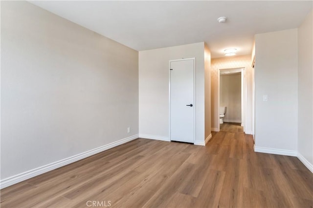 unfurnished room featuring wood-type flooring