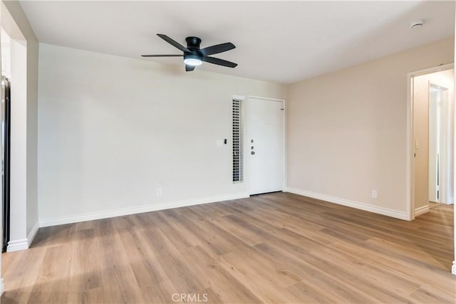 empty room featuring ceiling fan and light hardwood / wood-style floors