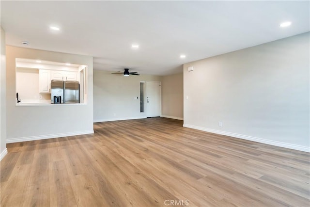 unfurnished living room featuring light hardwood / wood-style floors and ceiling fan