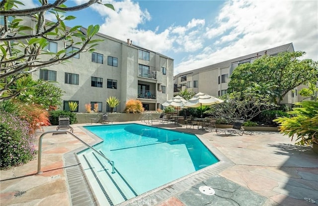 view of swimming pool featuring a patio and cooling unit