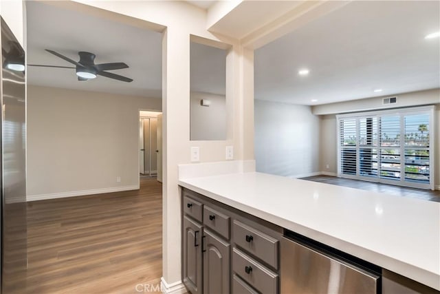 kitchen featuring gray cabinets, ceiling fan, and light hardwood / wood-style flooring