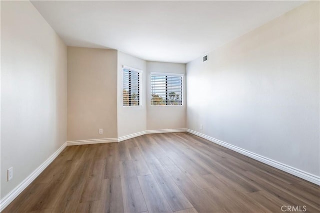 unfurnished room with dark hardwood / wood-style floors