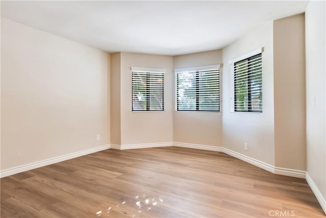 unfurnished room featuring light hardwood / wood-style floors