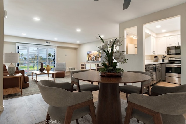 dining area featuring light wood-type flooring