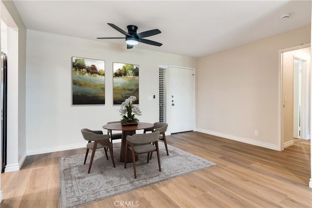 dining space with light hardwood / wood-style flooring and ceiling fan