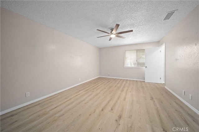 spare room with a textured ceiling, light hardwood / wood-style floors, and ceiling fan