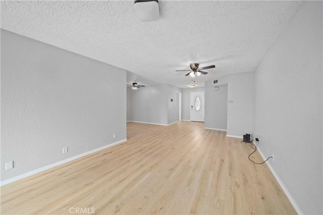 unfurnished living room featuring light hardwood / wood-style floors and a textured ceiling