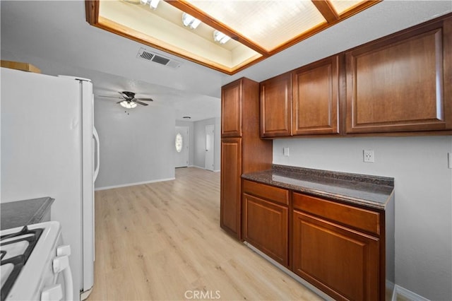 kitchen featuring white appliances, light hardwood / wood-style flooring, and ceiling fan