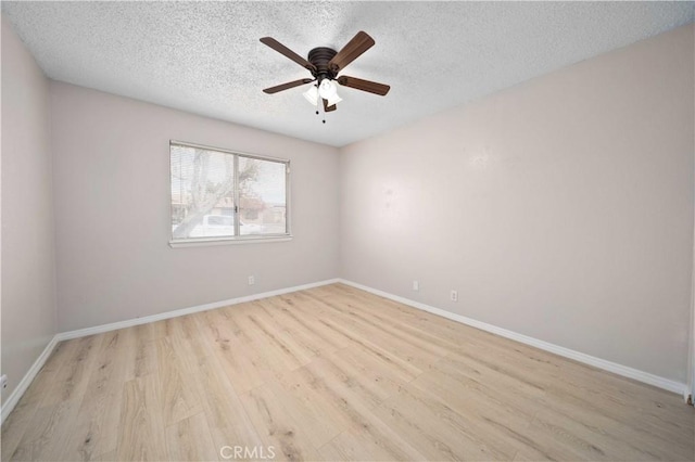 unfurnished room featuring ceiling fan, a textured ceiling, and light wood-type flooring