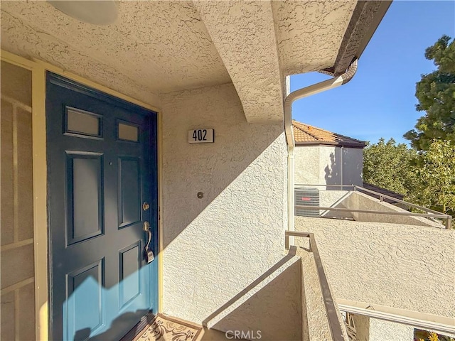 entrance to property featuring a balcony