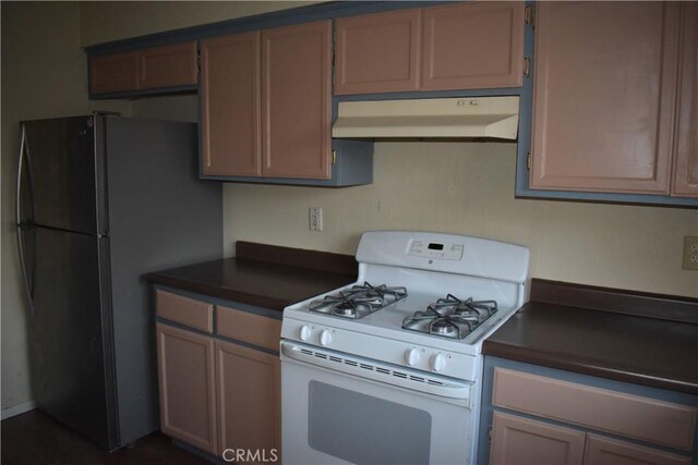 kitchen featuring black fridge and gas range gas stove