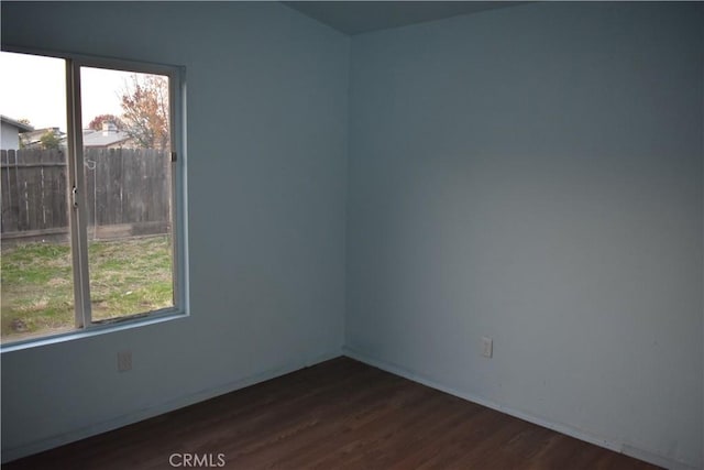 spare room with dark hardwood / wood-style flooring