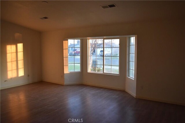 unfurnished room featuring dark hardwood / wood-style flooring