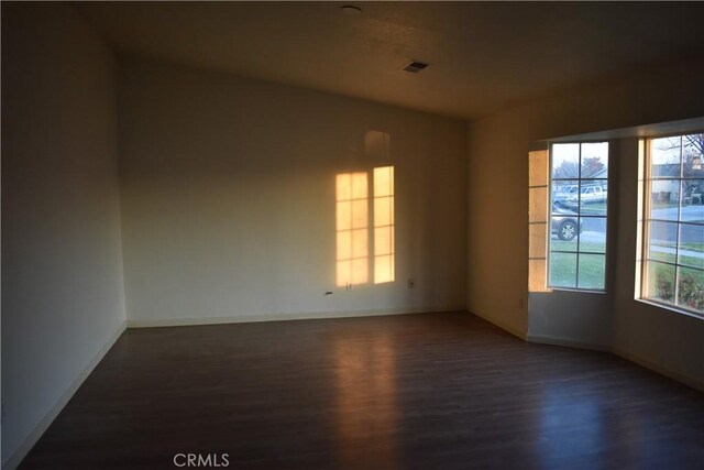 unfurnished room featuring dark hardwood / wood-style flooring