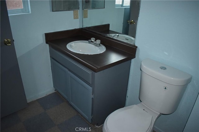 half bath featuring toilet and vanity