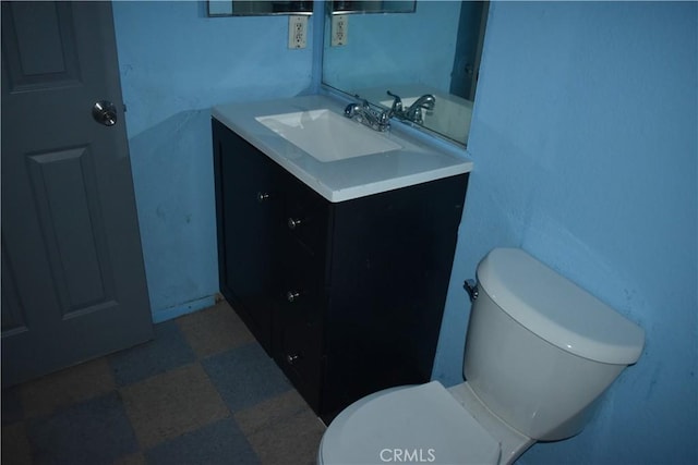 bathroom with vanity, tile patterned floors, and toilet