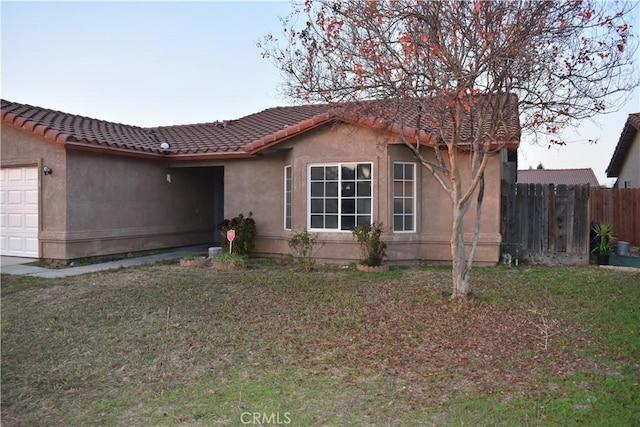 view of front facade with a front yard and a garage