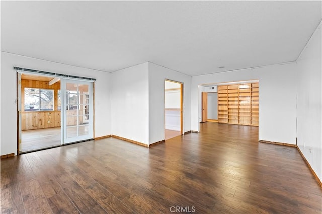 empty room with dark hardwood / wood-style flooring