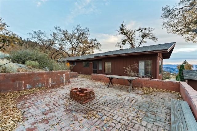 view of patio featuring a mountain view and an outdoor fire pit