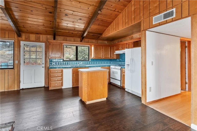 kitchen featuring a kitchen island, white appliances, dark wood-type flooring, and tasteful backsplash