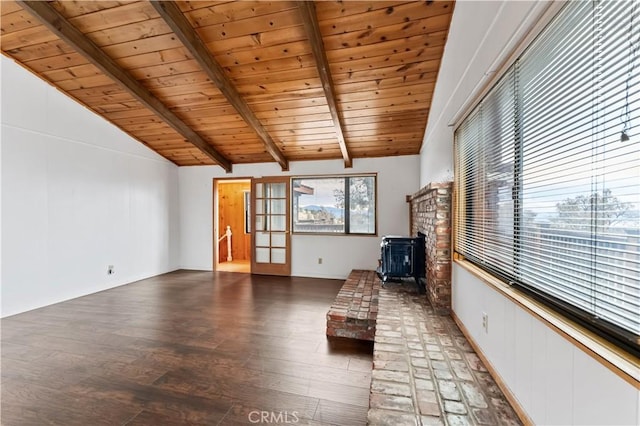 unfurnished room with a wood stove, wood ceiling, dark hardwood / wood-style floors, and vaulted ceiling with beams